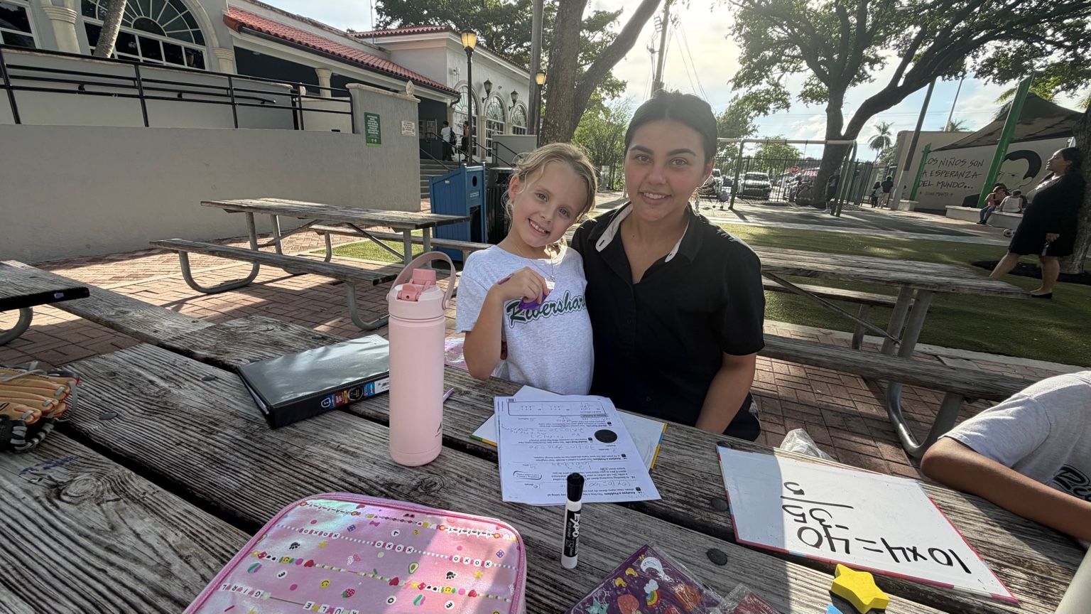 Ms. Liu tutoring a student outdoors
